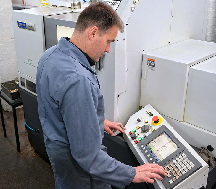 MANUFACTURER BUYS SLIDING-HEAD LATHES BUT MACHINES COMPONENTS WITHOUT THE GUIDE BUSH